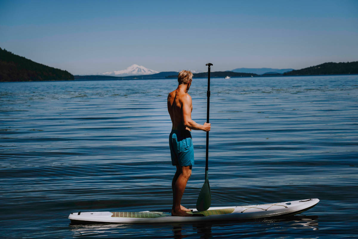 Man Paddle Boarding off the Beach at Anderson Lane
